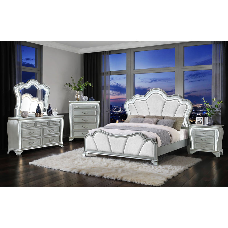 Silver upholstered bed set with matching dresser and nightstands in a bedroom setting