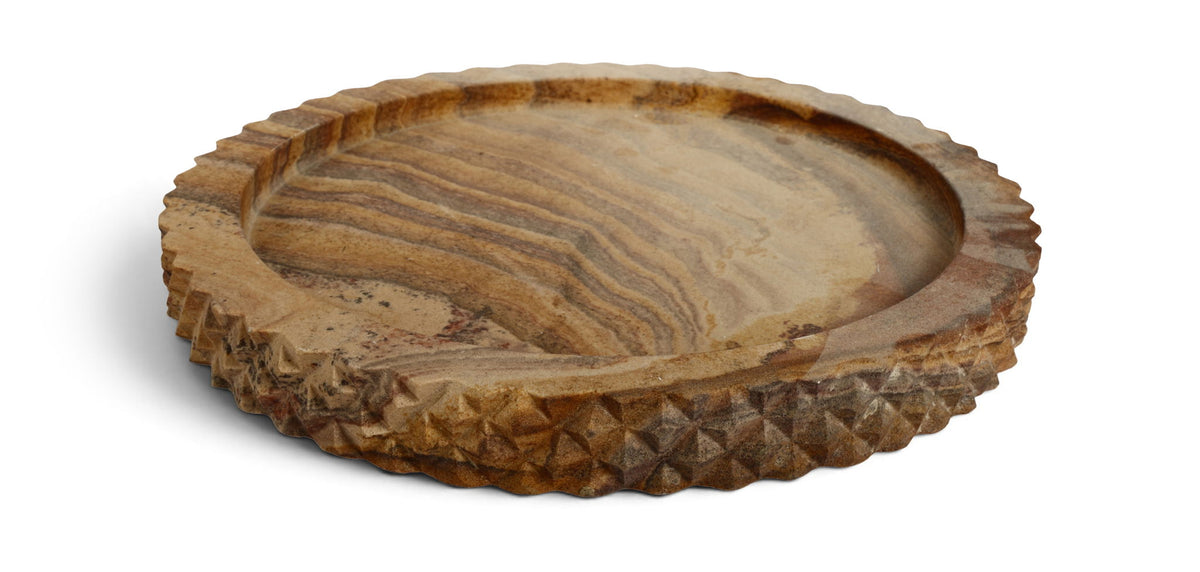 Sandstone round tray in sand with layered wood-grain stripes and scalloped edge