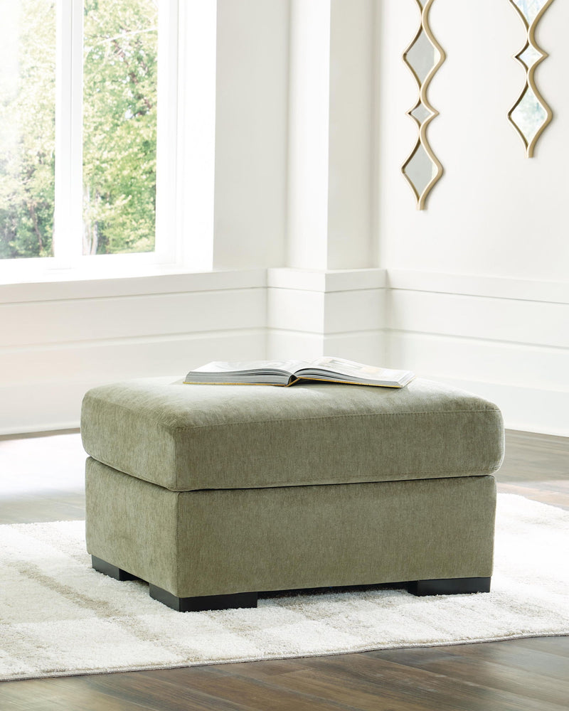 Green fabric ottoman with rounded seat and dark block feet