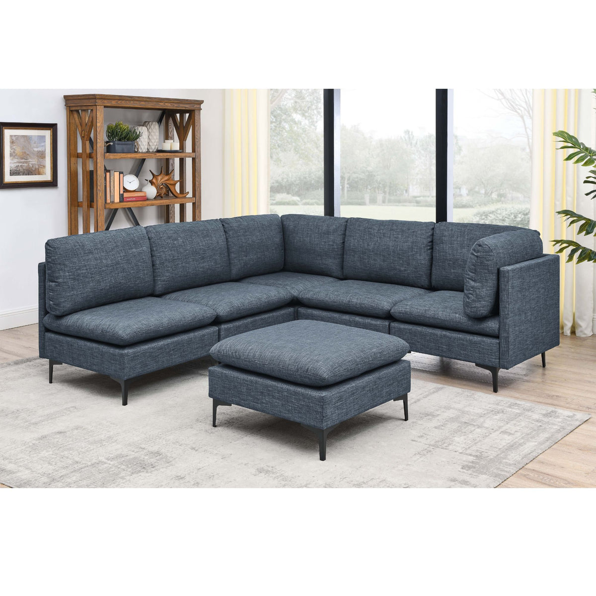 Dark gray modular sectional with tall legs and ottoman pouf