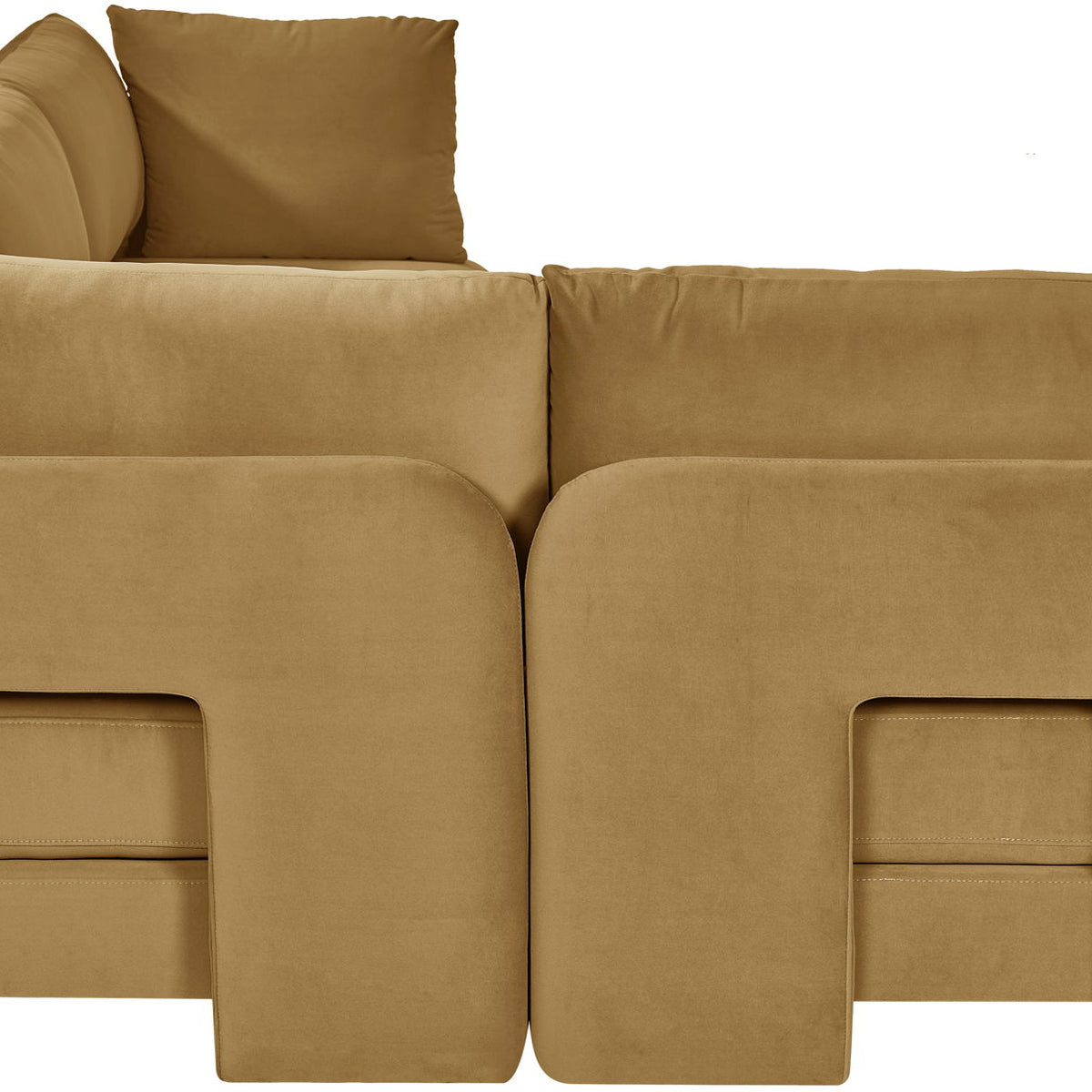 Tan velvet armless sectional sofa, close-up view of rounded arm and inner panel