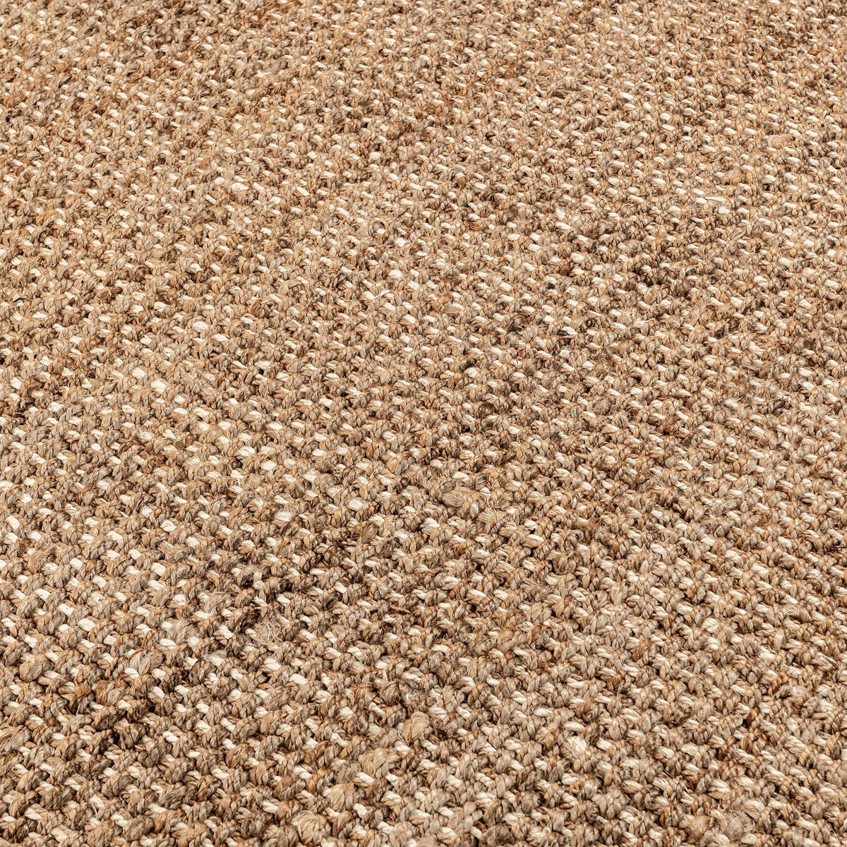 Close-up of woven jute rug texture in light beige and tan threads