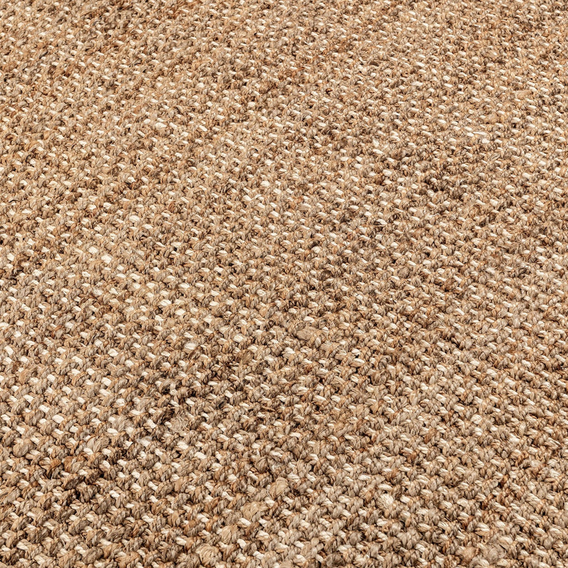 Close-up of woven jute rug texture in light beige and tan threads