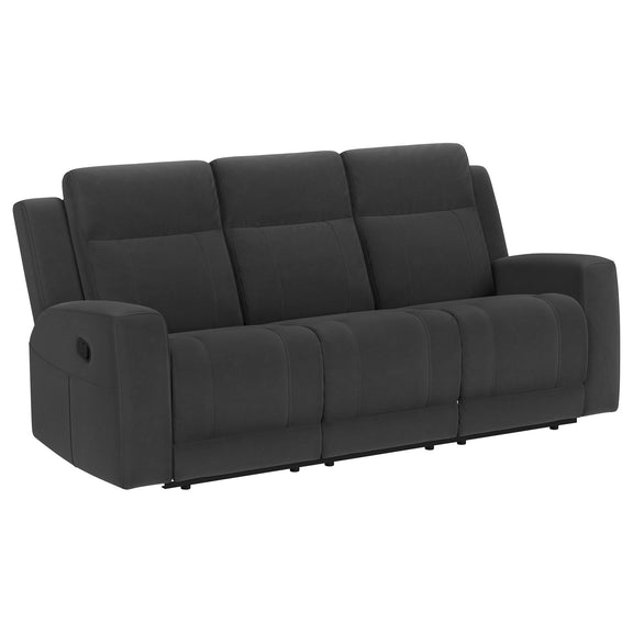 Dark gray reclining sofa with manual recline, tufted back cushions and wide padded arms