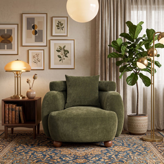 Olive green accent chair with back pillow, rounded arms, and wooden legs