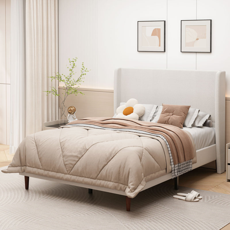 Beige upholstered bed with tall headboard, shown from an angled view