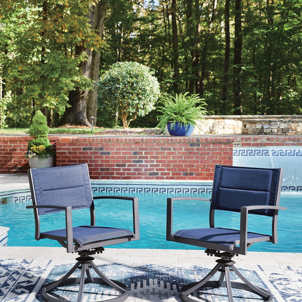 Two blue sling swivel chairs with gray frames and round swivel bases