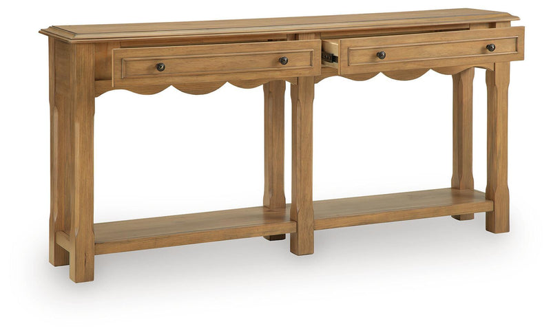 Light brown console sofa table with scalloped apron, two drawers, and open shelves