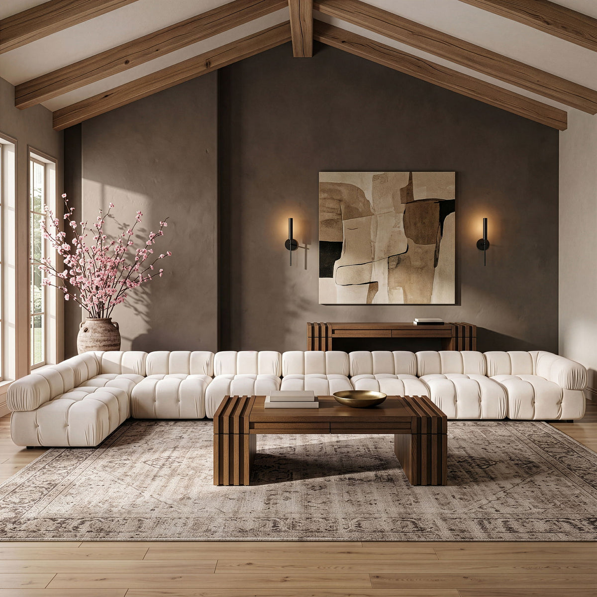 White velvet L-shaped sectional sofa with tufted back cushions and rounded arms.