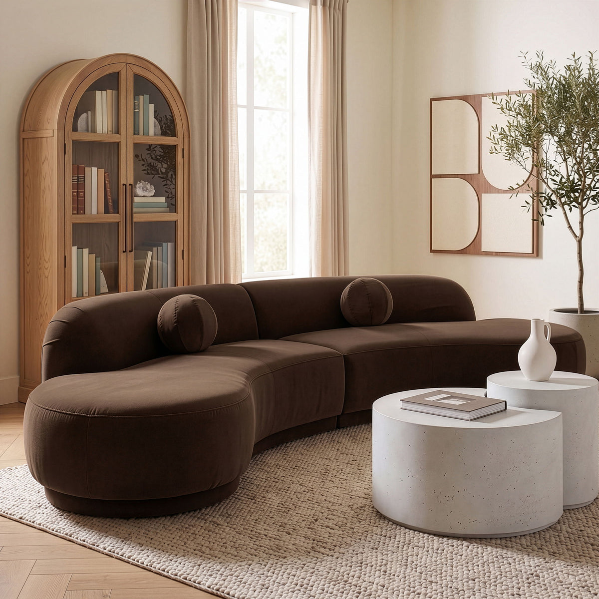 Dark brown velvet sectional sofa with rounded arms and cushioned chaise