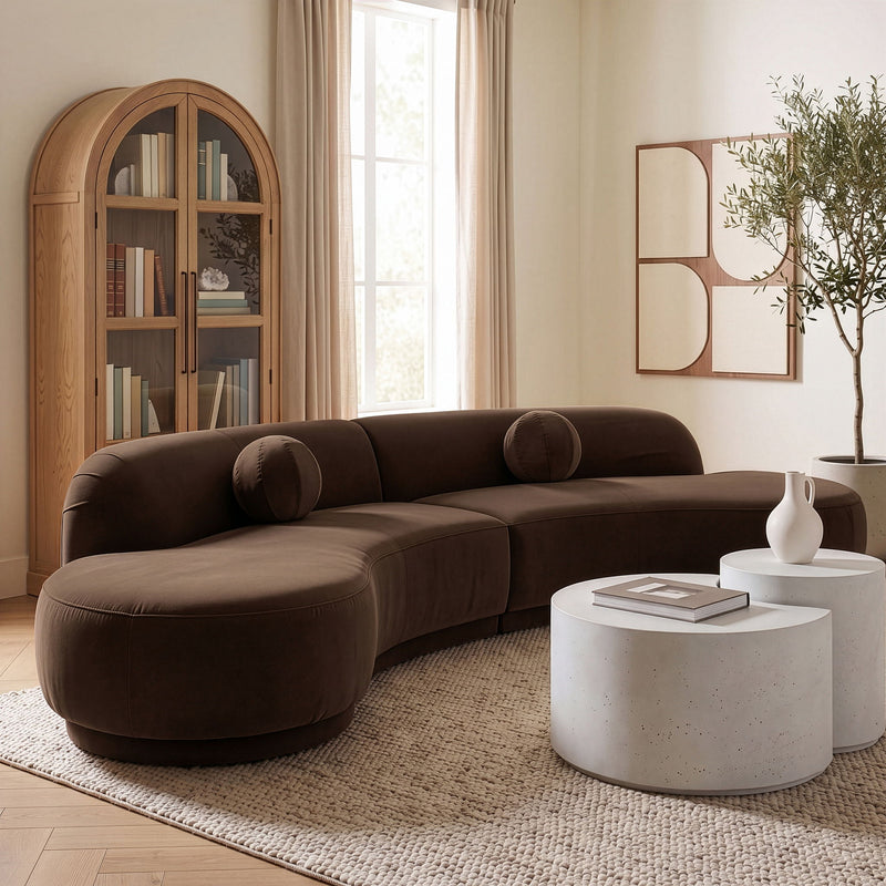 Dark brown velvet sectional sofa with rounded arms and cushioned chaise
