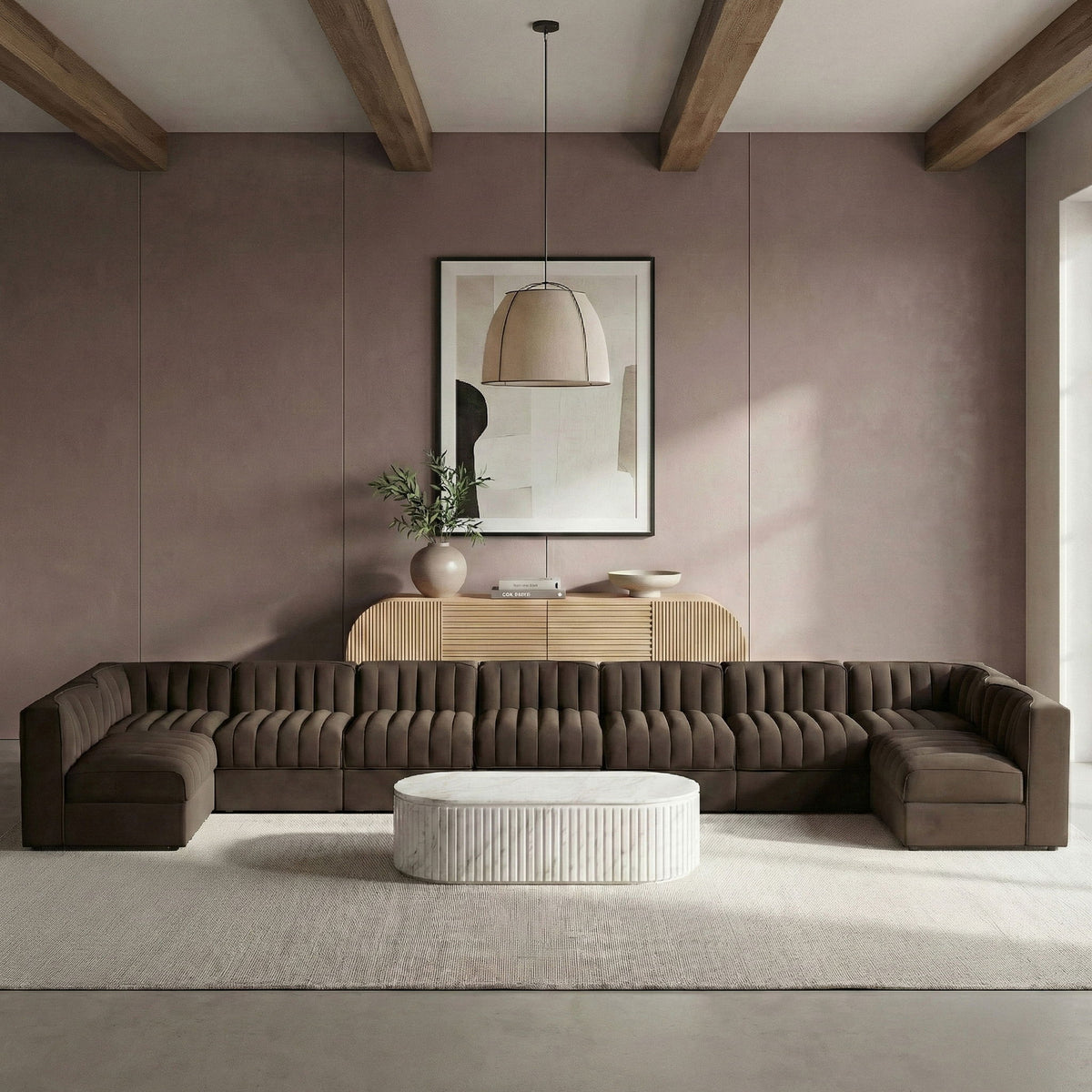 Dark gray armless velvet modular sectional with tufted back and matching low corner ottomans
