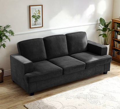 3-seater sofa in dark gray fabric with loose back cushions and wide arms.