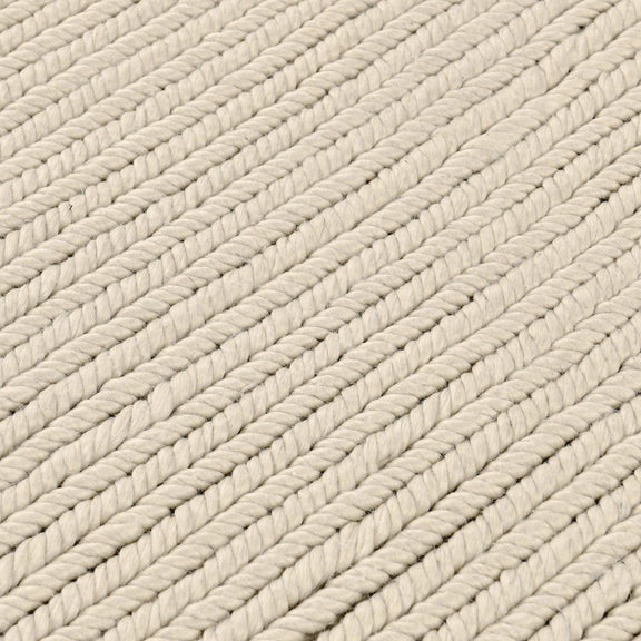 Dawson rug close-up in off-white with diagonal braided yarn rows and soft gray accents