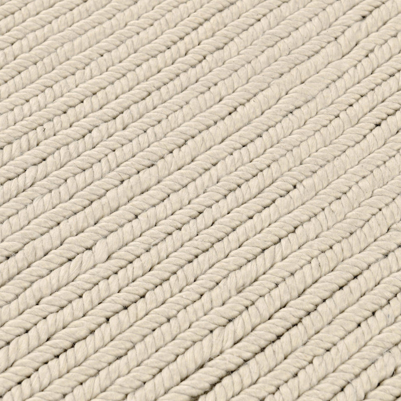 Dawson rug close-up in off-white with diagonal braided yarn rows and soft gray accents