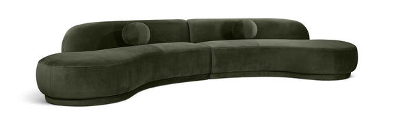 Dark green velvet sectional sofa with tufted cushions and curved chaise profile