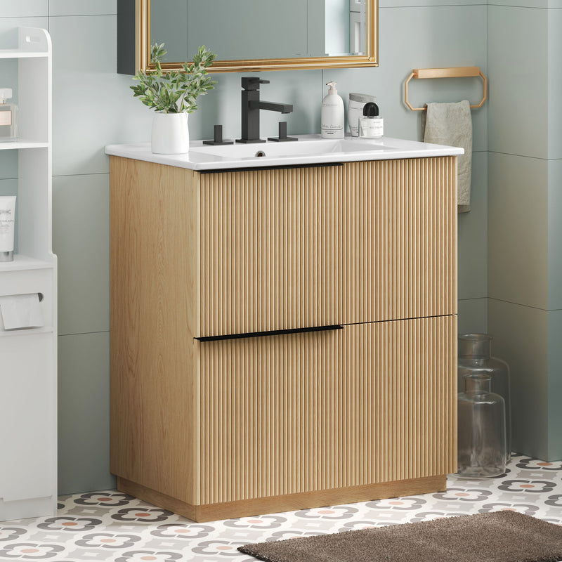 Light brown fluted bathroom vanity with white ceramic sink and center handle bar