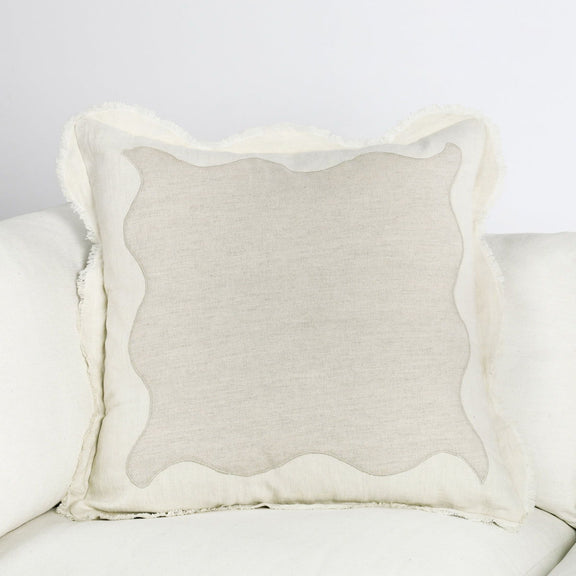 Tollo beige linen square pillow on sofa with scalloped edges and textured weave
