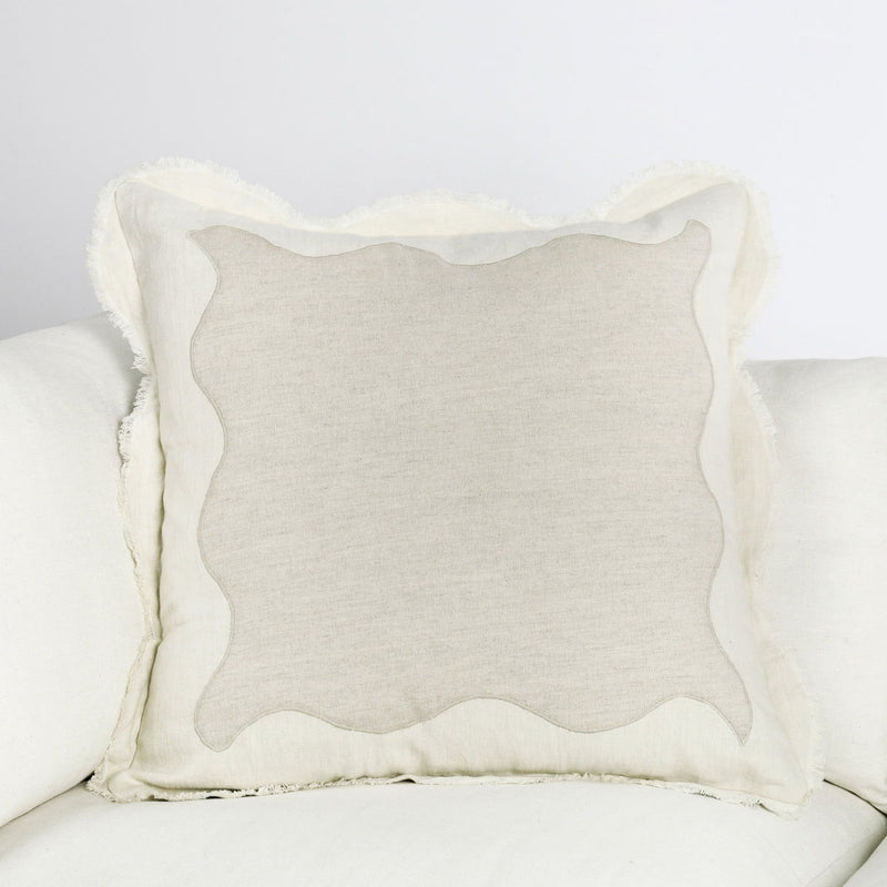 Tollo beige linen square pillow on sofa with scalloped edges and textured weave