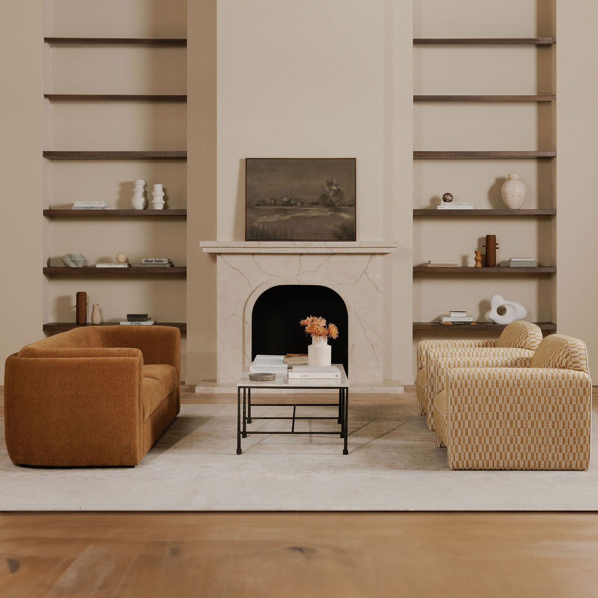 Dark brown framed landscape painting above a white fireplace in living room