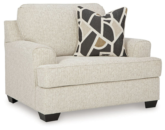 Light gray chair and a half sofa with geometric accent cushion