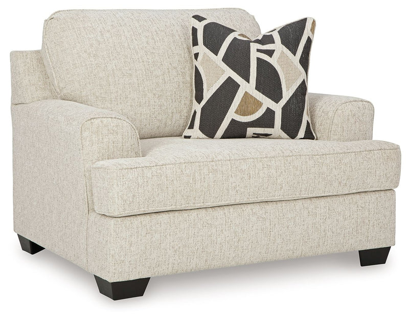 Light gray chair and a half sofa with geometric accent cushion