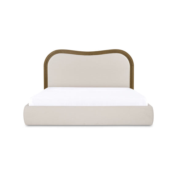 Beige upholstered king bed with arched headboard and brown frame trim, platform base