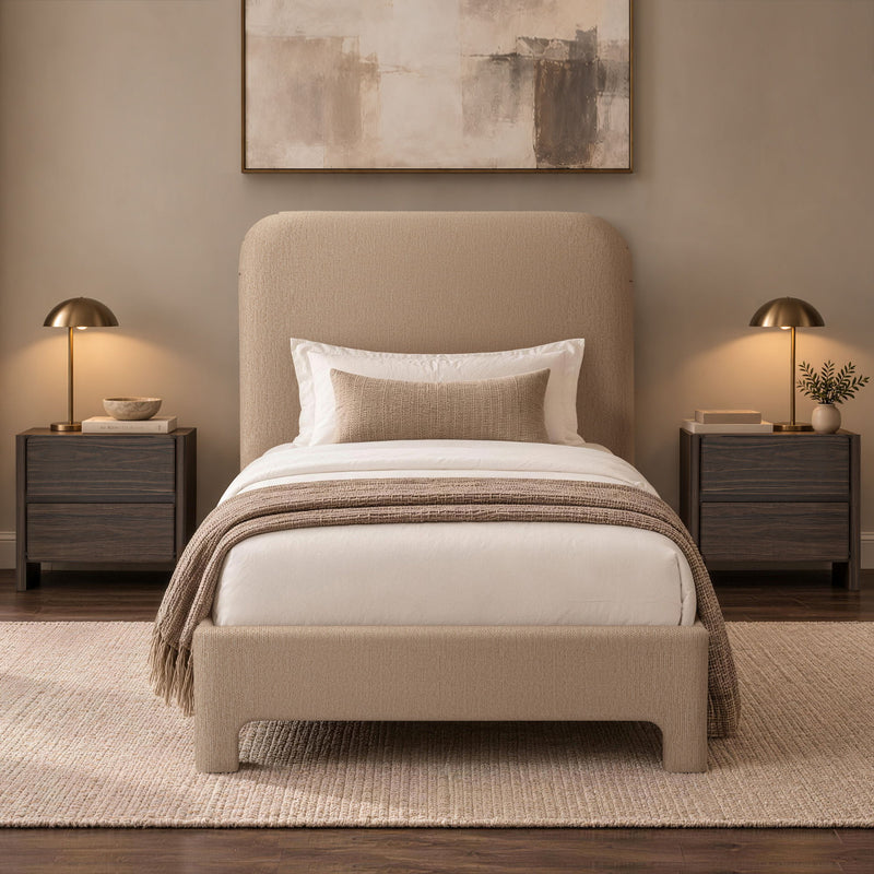 Beige upholstered bed with rounded headboard, white bedding, and draped throw blanket
