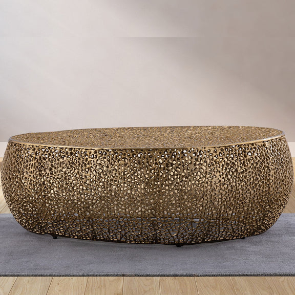 Gold oval coffee table with textured mosaic pattern and low rounded base, angled view