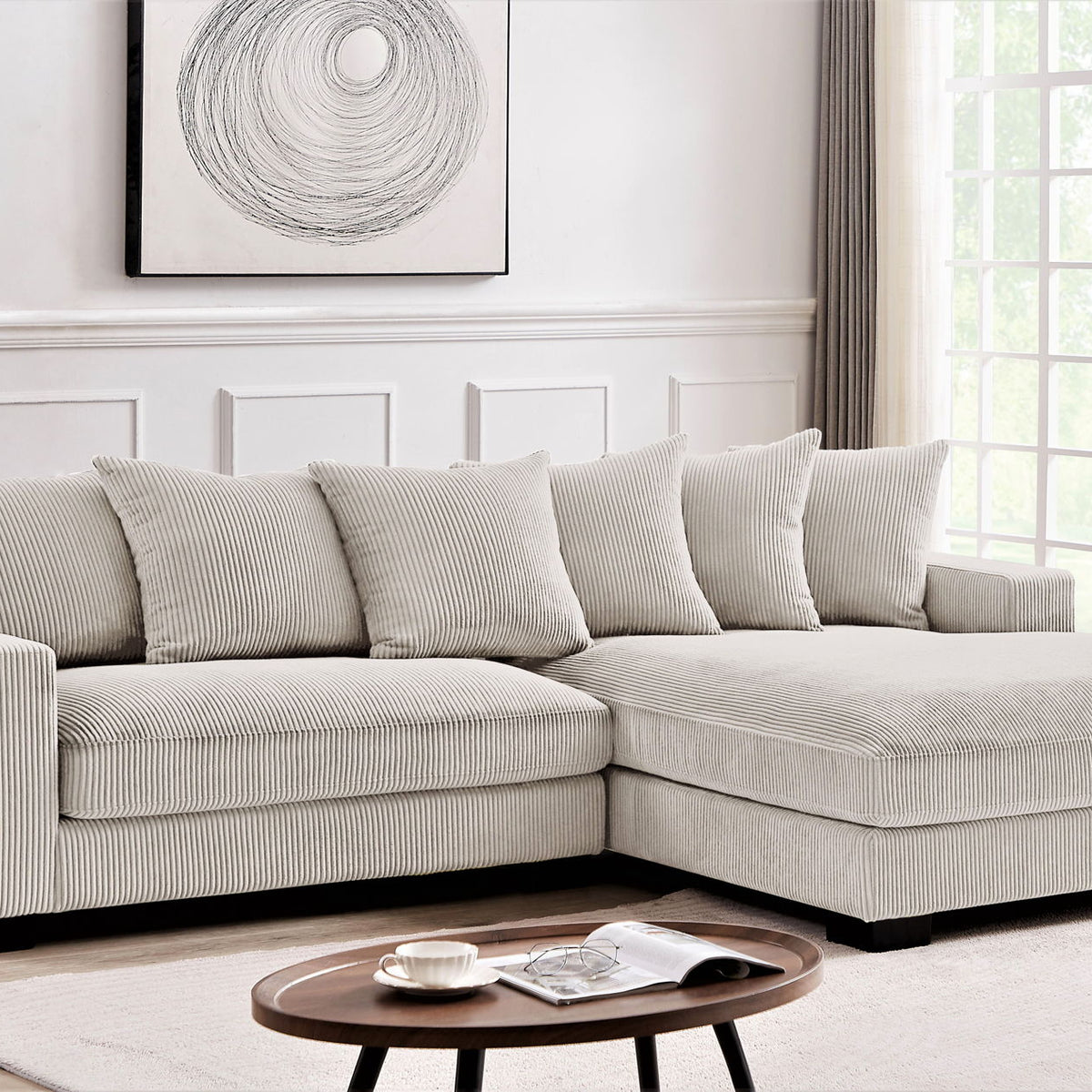 Light gray L-shaped sectional sofa with chaise and five back pillows