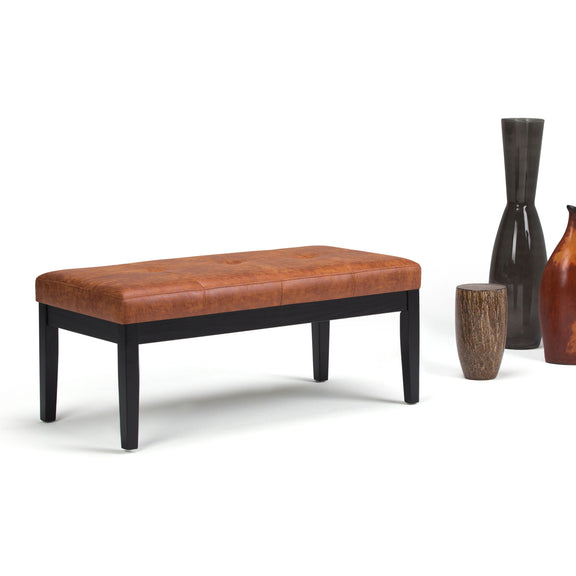 Lacey tufted ottoman bench in brown faux leather with black legs