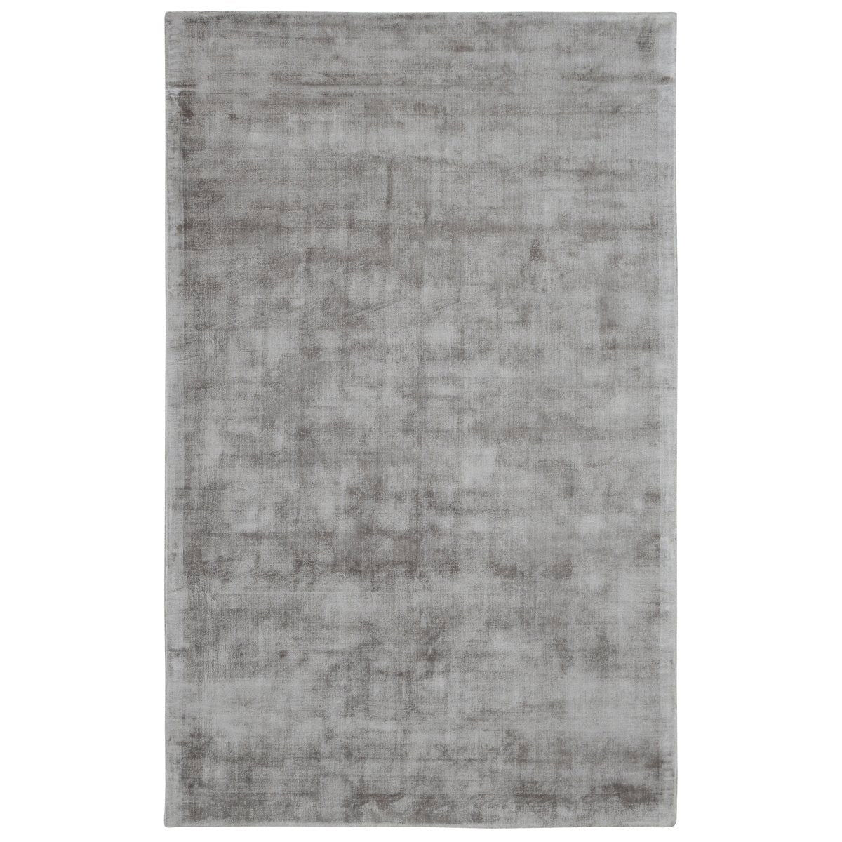 Medium light gray distressed area rug with mottled vintage pattern and flat pile.