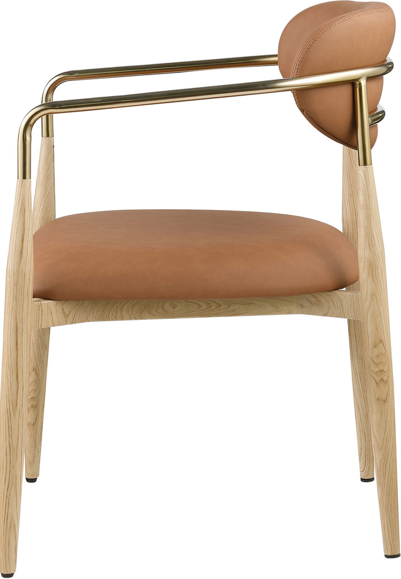Vegan leather dining arm chair with tan seat and rounded back, gold-tone arms, wood legs