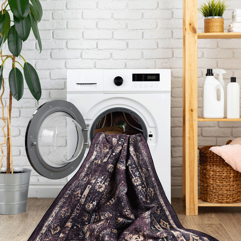 Dark patterned area rug under front-load washer, rectangular 2x3 ft