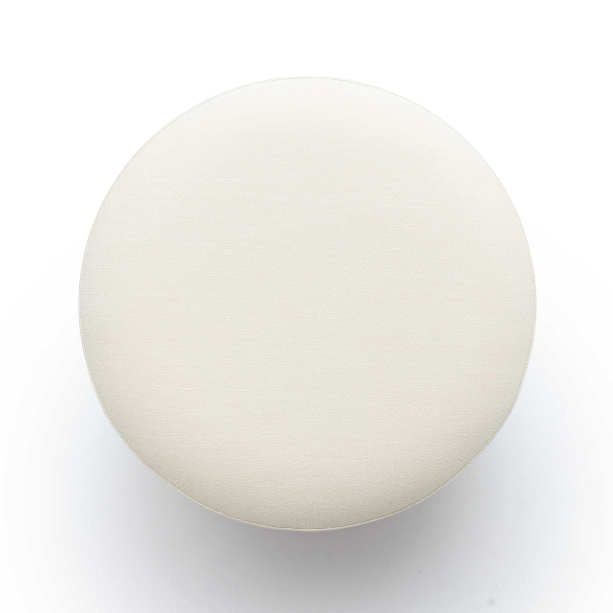 White round ottoman top view, upholstered fabric surface