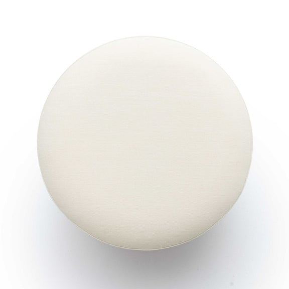 White round ottoman top view, upholstered fabric surface