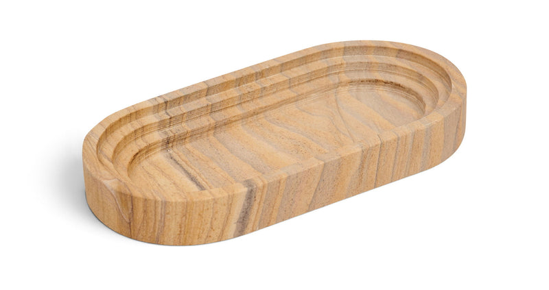Light wood-toned marble oval tray with carved concentric groove pattern