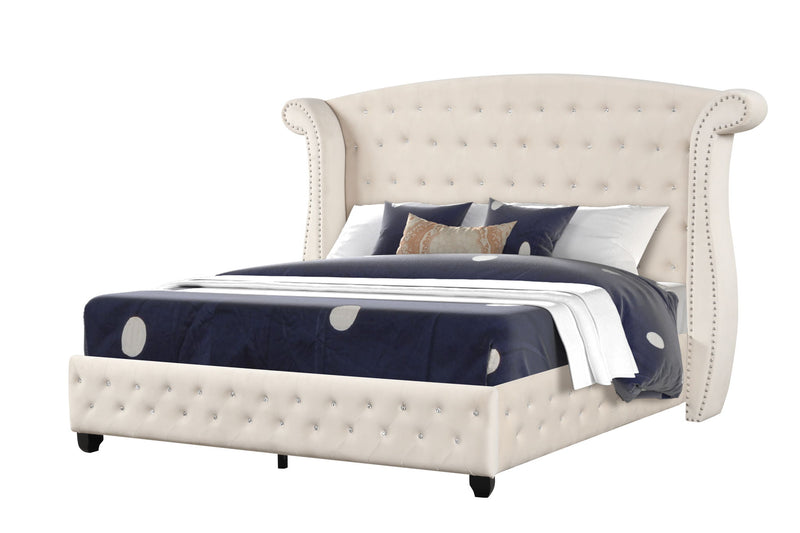 Beige tufted upholstered bed with crystal button detailing and navy comforter.