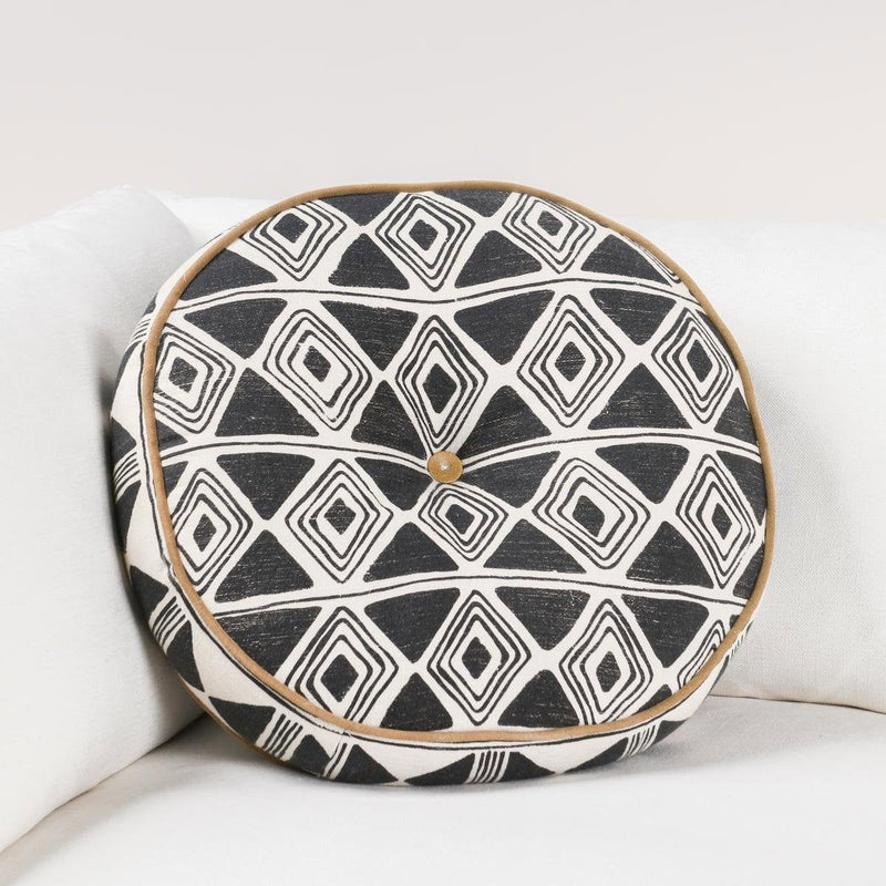 18-inch round pillow with black and white geometric print, tan piping, small center button