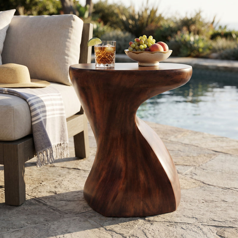 Twisted sculptural side table with round top and dark brown sculpted base