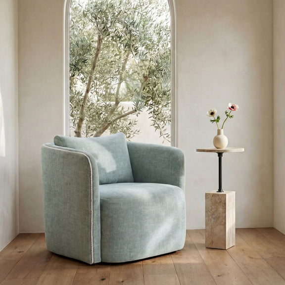 Light blue upholstered accent chair with rounded arms and padded backrest