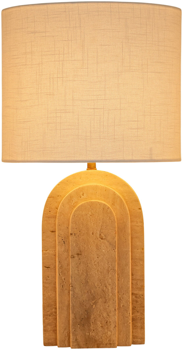 Table lamp with tan fabric shade and warm tan arched stone base