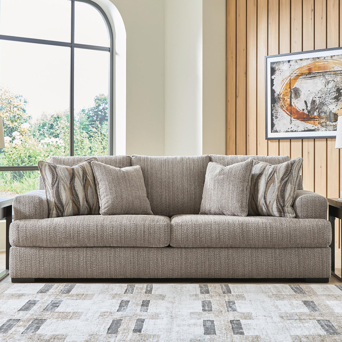 Lofwood sofa with gray upholstery and mix of solid and patterned throw pillows