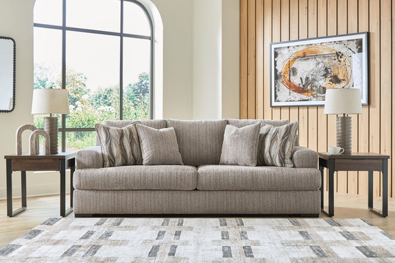 Lofwood sofa with gray upholstery and mix of solid and patterned throw pillows