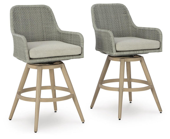 Pair of beige-gray woven barstools with seat cushions and light wood bases