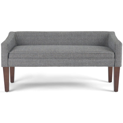 Gray upholstered bench with cushioned seat, boxy arms, and dark wooden legs