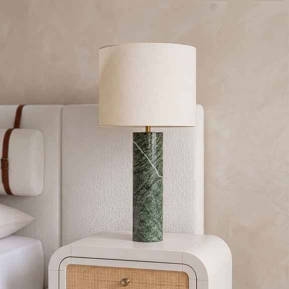 Textured fabric table lamp with white drum shade and green marbled cylindrical base