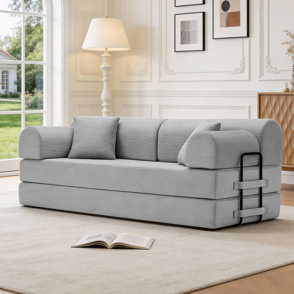 Light gray convertible sleeper sofa bed with three back cushions and dark side handle detail