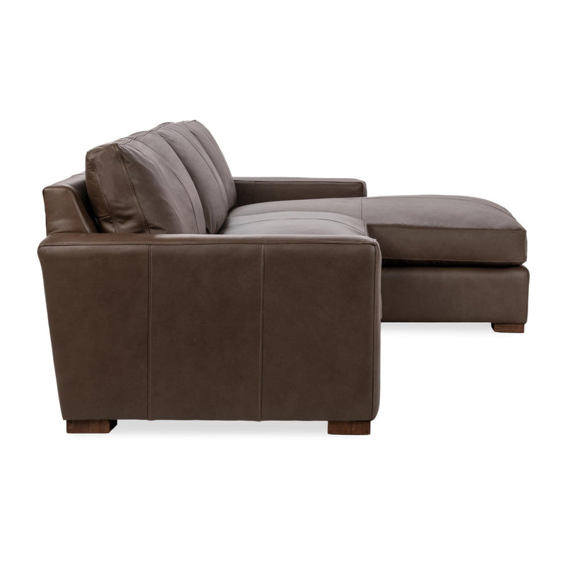 Brown chaise sofa with deep seating, back pillows, and chaise section for lounging