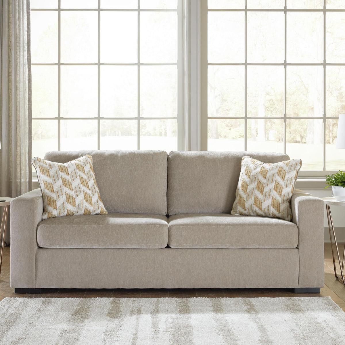 Bridgepoint sofa in light beige fabric with two seat cushions and two patterned pillows